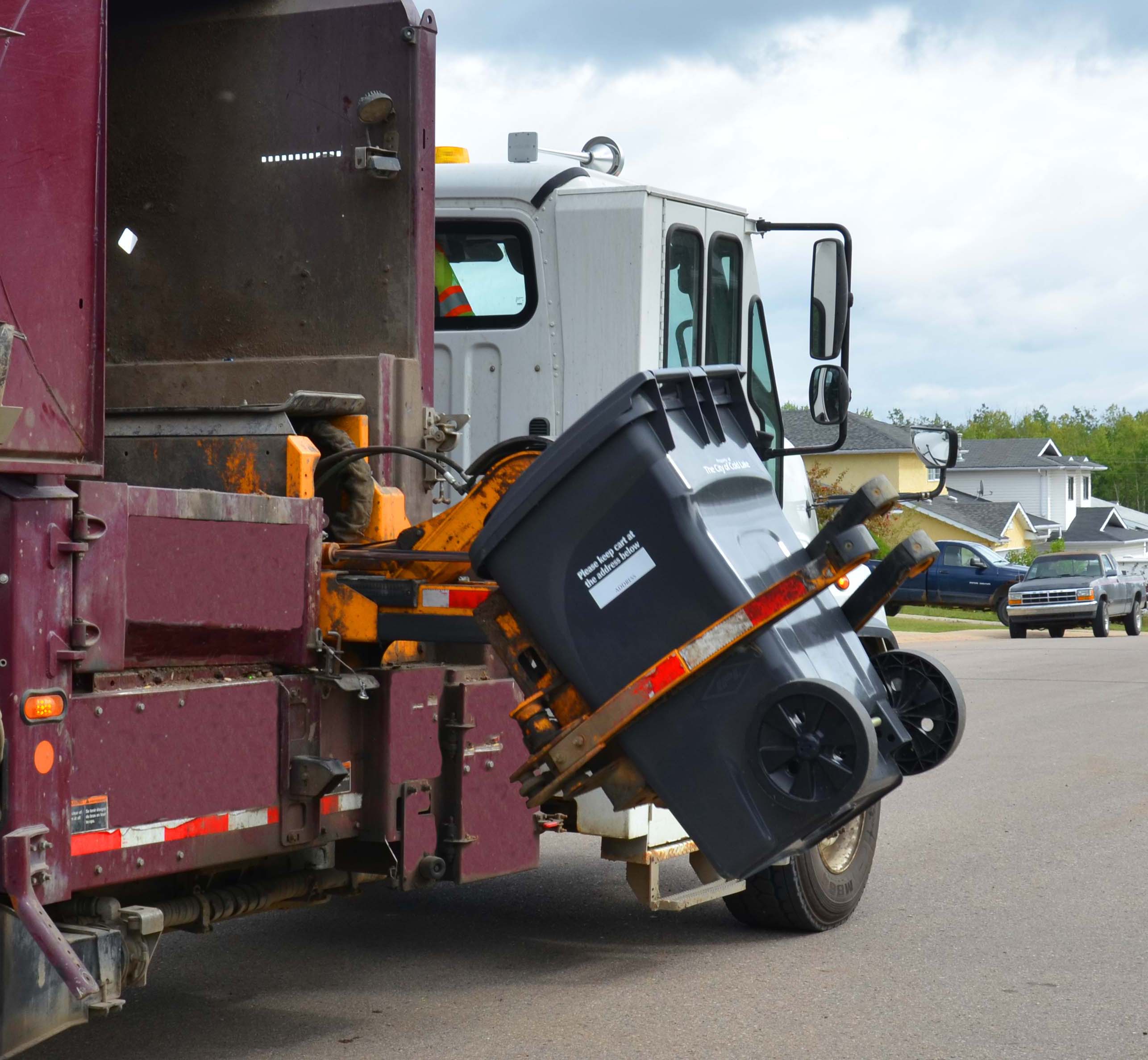 garbage truck emptying cart
